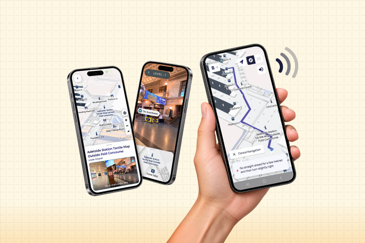 A hand holds a smartphone displaying a navigation pathway to a bus stop. In the background, two other screenshots are displayed of accessibility features navigate Adelaide Railway Station.