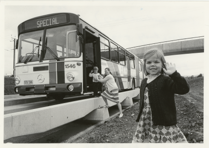 View A family photographed with an O-Bahn bus.