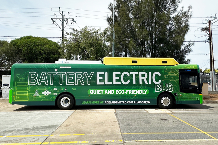Green bus with the words 'battery electric bus' on the side.