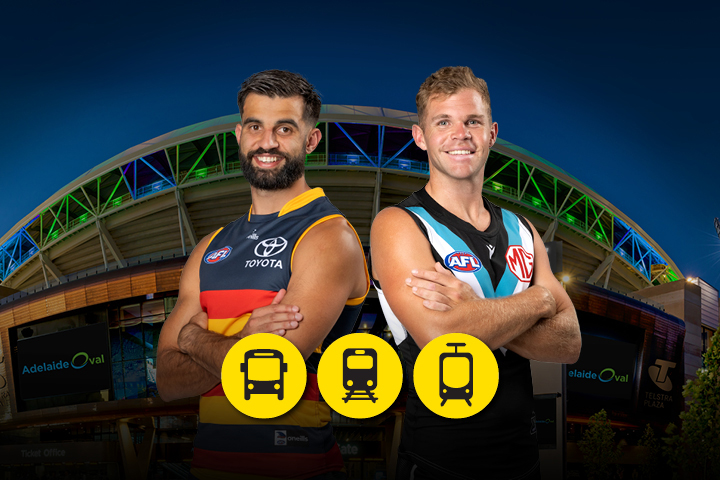 A Crows and Port player posing back to back in front of Adelaide Oval. The bus, train and tram icons are displayed below in a yellow circle.